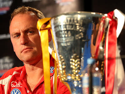 Sydney coach John Longmire eyes off the trophy.