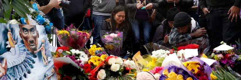 Fans gathered near a memorial for Kobe Bryant at Staples Center in downtown Los Angeles.