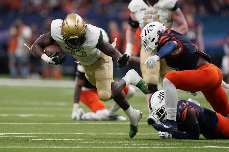 UAB running back DeWayne McBride (22) is tripped up on a run during the first half of an NCAA college football game against UTSA , Saturday, Nov. 20, 2021, in San Antonio. (AP Photo/Eric Gay)