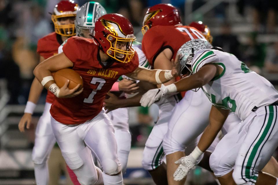 Big Walnut's Nate Severs (7) stiff-arms Dublin Scioto's Cameron Jackson Jr. (25) during the host Golden Eagles' 28-20 win Oct. 15.