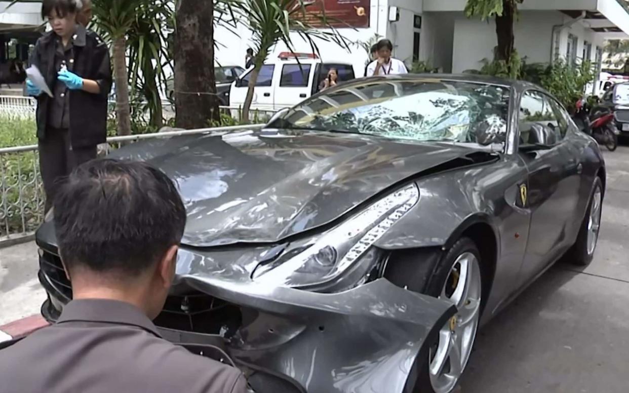 Police inspecting the Ferrari belonging to Red Bull heir Vorayuth 'Boss' Yoovidhya in Bangkok - AFP