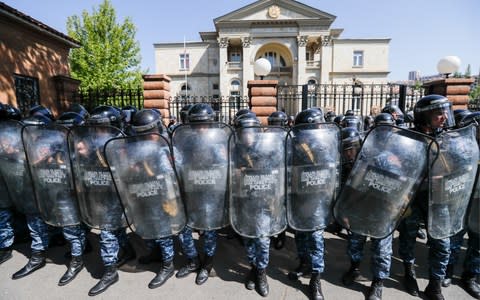 Police gather outside the Residence of the President of Armenia as protests continued - Credit:  Artyom Geodakyan/ TASS