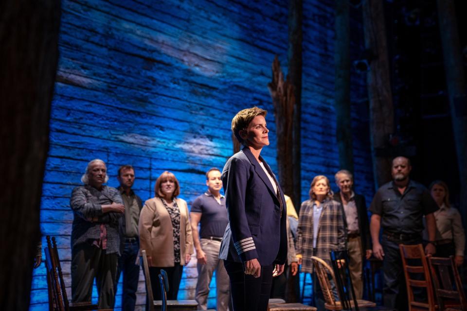 The cast of Come From Away sing together onstage