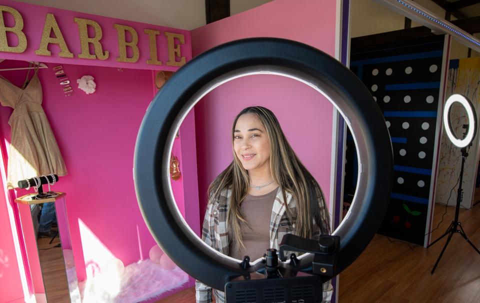 Carmen Rodriguez poses in front of a ring light at her Capture the Moments Selfie Room on Southbridge Street in Auburn.