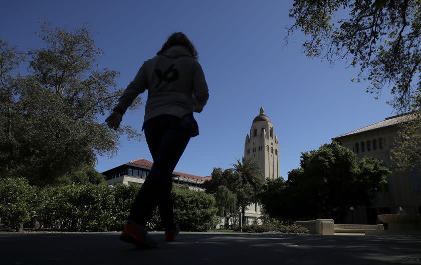 In this April 9, 2019 photo, Hoover Tower is shown at rear on the campus at Stanford University in Stanford, Calif. (AP Photo/Jeff Chiu)