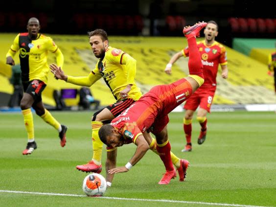 Watford's Kiko Fermenia knocks Norwich's Onel Hernandez off the ball (PA)