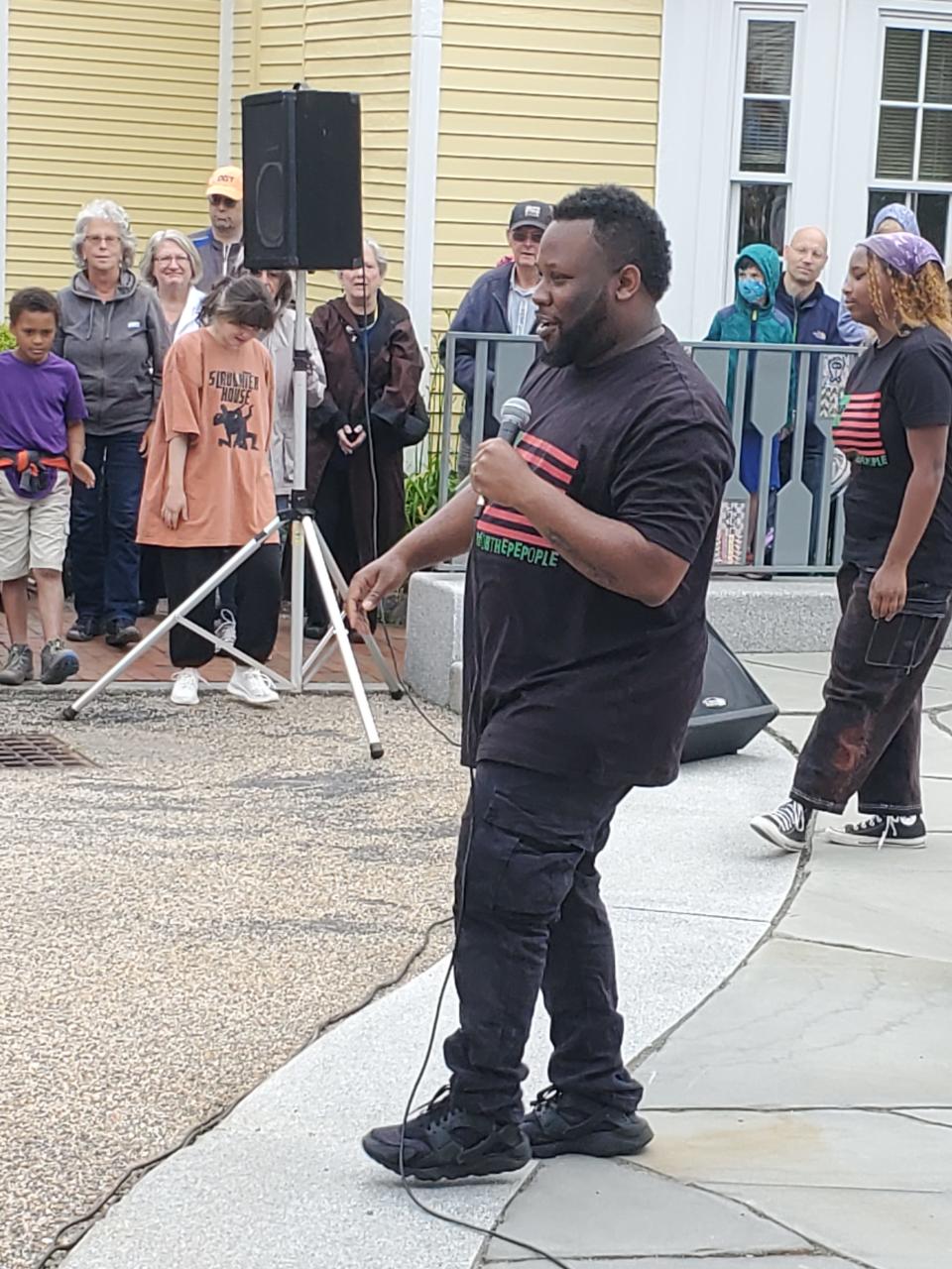 Najee Brown, founder of Theater For The People, gives a dance lesson during "Uproar: A Celebration of African American Creativity,“ a Juneteenth performance at the African Burying Ground Memorial Park in Portsmouth Sunday, June 19, 2022.
