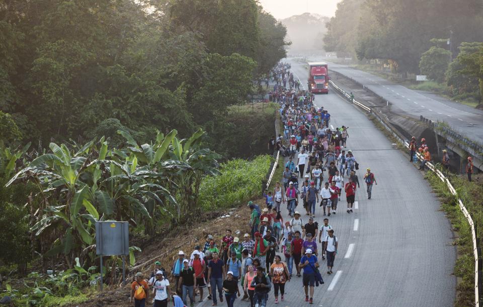 Central American migrants traveling with a caravan to the U.S. make their way to Mapastepec, Mexico, Wednesday, Oct. 24, 2018. Thousands of Central American migrants renewed their hoped-for march to the United States on Wednesday, setting out before dawn with plans to travel another 45 miles (75 kilometers) of the more than 1,000 miles that still lie before them. (AP Photo/Rodrigo Abd)