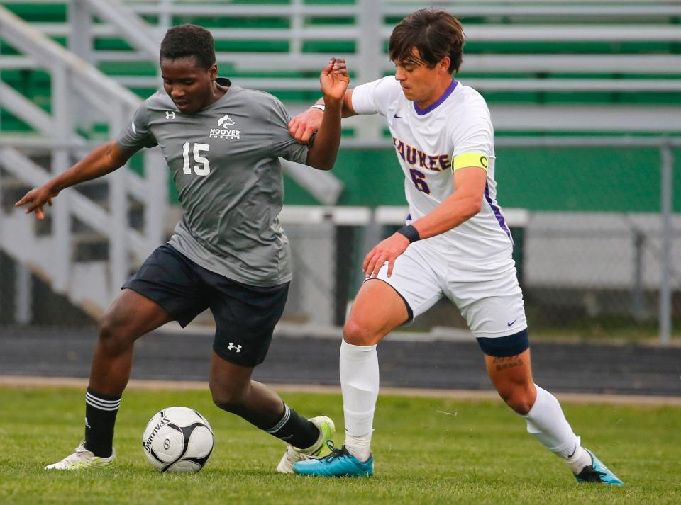 Majaliwa Irene, left, of Hoover battles for the ball during a game against Waukee on Monday.