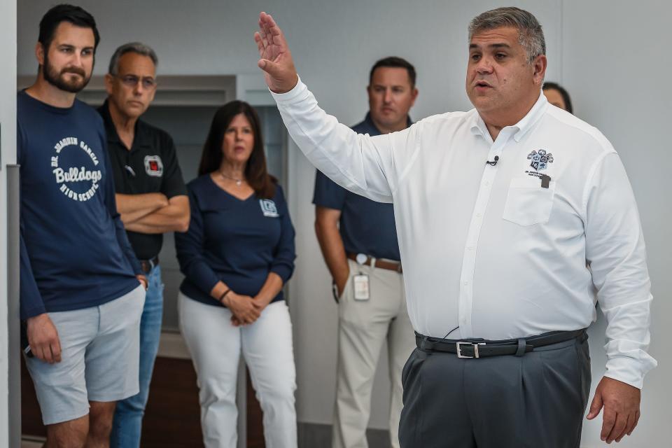 Principal Oscar Otero speaks to reporters on Tuesday during a tour of the new Dr. Joaquin Garcia High School in unincorporated Palm Beach County.