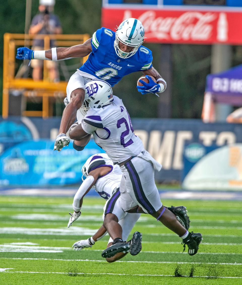 West Florida's John Jiles jumps over Kentucky Wesleyan players during action against Kentucky Wesleyan at the University of West Florida Friday, September 1, 2023.