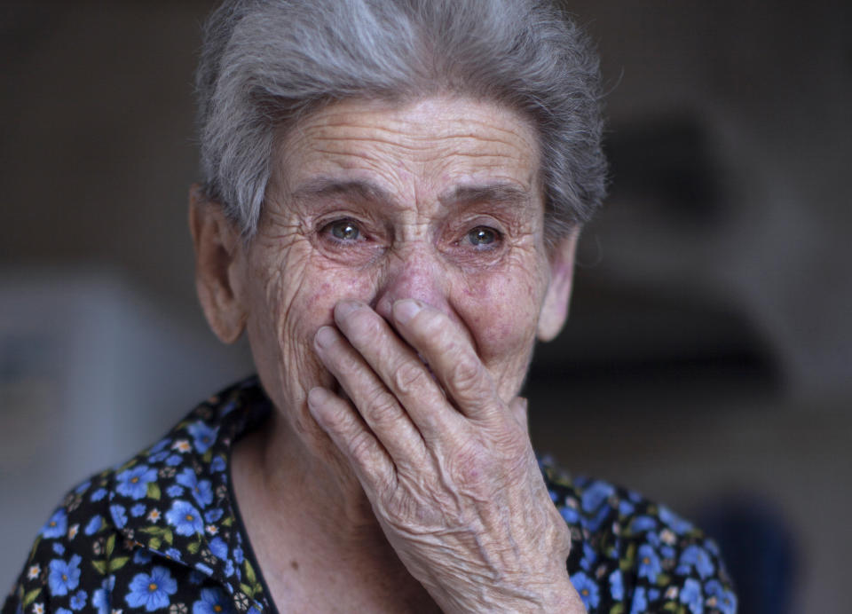 Ethnic Armenian Rosa reacts after her house was damaged during shelling in the town of Martuni, self-proclaimed Republic of Nagorno-Karabakh, Azerbaijan, Tuesday, Sept. 29, 2020. Heavy fighting between Armenian and Azerbaijani forces over the separatist region of Nagorno-Karabakh continued for a fourth straight day on Wednesday, in the biggest escalation of a decades-old conflict in years that has killed dozens and left scores of others wounded. (AP Photo/Karen Mirzoyan)