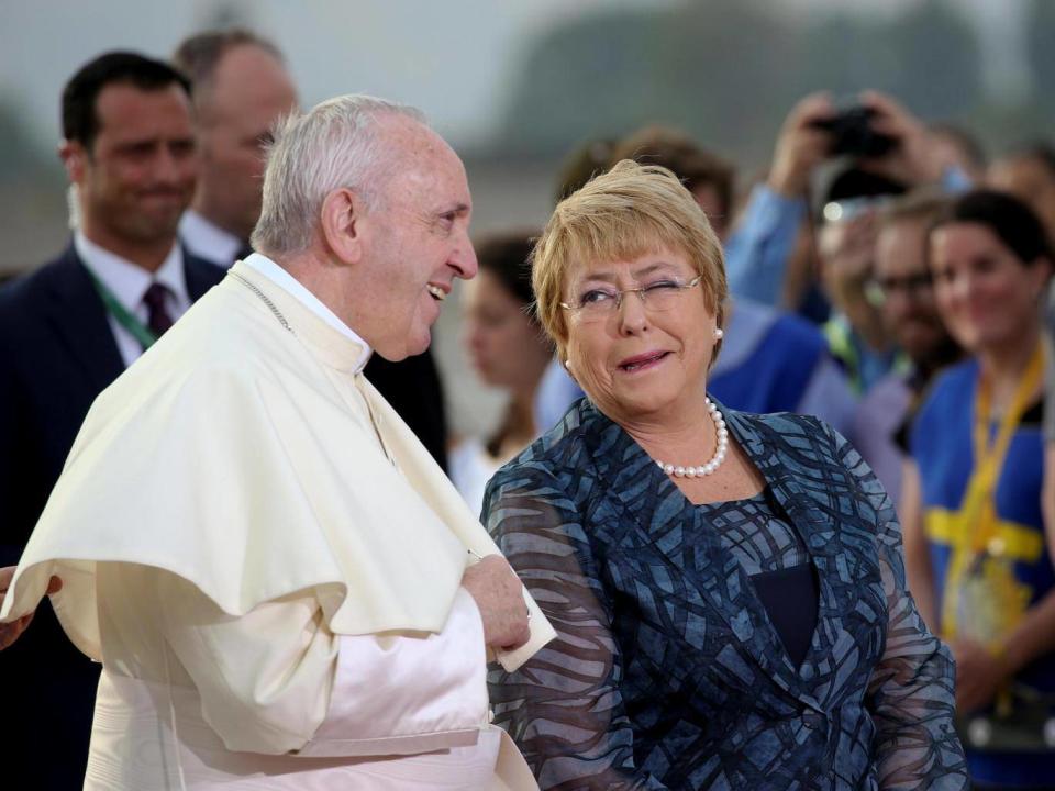 Pope Francis is greeted by Chile's President Michelle Bachelet upon his arrival in Santiago (Alessandro Bianchi/Reuters)