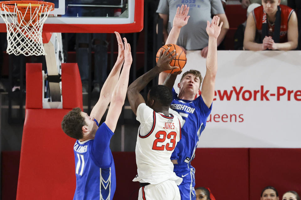 St. John's forward David Jones (23) drives to the basket against Creighton center Ryan Kalkbrenner (11) and guard Baylor Scheierman, right, during the first half of an NCAA college basketball game Saturday, Feb. 18, 2023, in New York. (AP Photo/Jessie Alcheh)