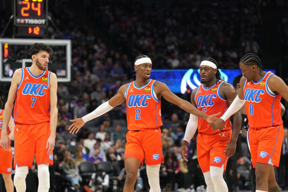Dec 14, 2023; Sacramento, California, USA; Oklahoma City Thunder guard Shai Gilgeous-Alexander (2) walks to the bench with forwards Chet Holmgren (7) and Jalen Williams (8) and guard Luguentz Dort (second from right) during the fourth quarter against the Sacramento Kings at Golden 1 Center. Mandatory Credit: Darren Yamashita-USA TODAY Sports