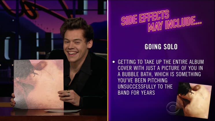 Harry Styles gives funny side effects of going solo. Holding up his new album. 