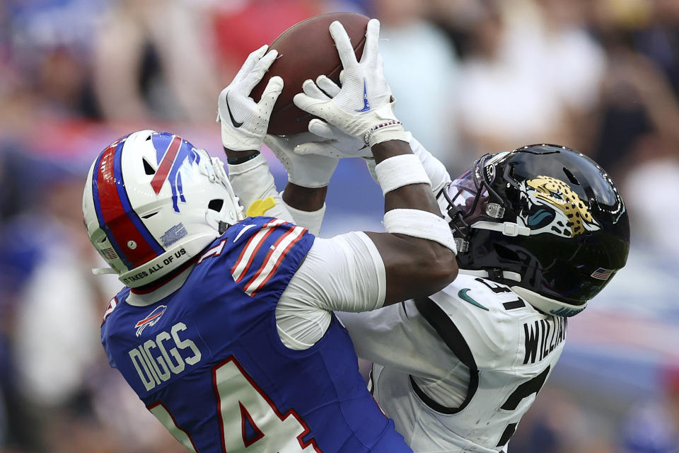 Jacksonville Jaguars cornerback Darious Williams (31) intercepts a pass for Buffalo Bills wide receiver Stefon Diggs (14) during an NFL football game between Jacksonville Jaguars and Buffalo Bills at the Tottenham Hotspur stadium in London, Sunday, Oct. 8, 2023. (AP Photo/Ian Walton)