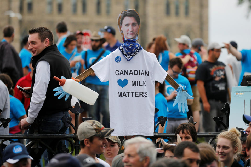 A sign featuring an image of Canada's Prime Minister Justin Trudeau is seen as dairy farmers protest against imported milk products in front of Parliament Hill in Ottawa, Ontario, Canada June 2, 2016. REUTERS/Chris Wattie