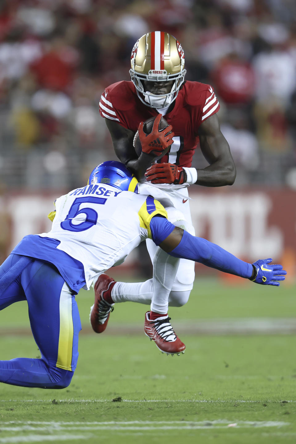 San Francisco 49ers wide receiver Brandon Aiyuk, top, runs against Los Angeles Rams cornerback Jalen Ramsey (5) during the second half of an NFL football game in Santa Clara, Calif., Monday, Oct. 3, 2022. (AP Photo/Jed Jacobsohn)