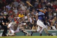 Seattle Mariners' Abraham Toro (13) follow through on this two-run home run in front of Boston Red Sox's Christian Vazquez during the fifth inning of a baseball game Friday, May 20, 2022, in Boston. (AP Photo/Michael Dwyer)