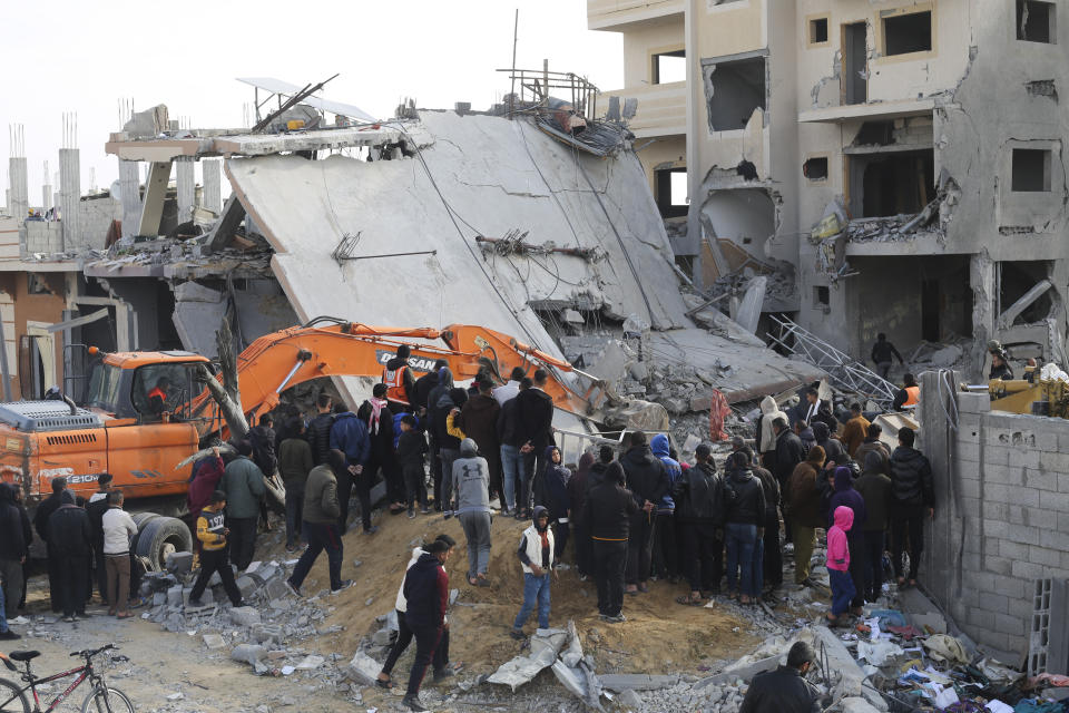 Palestinians look at the destruction after an Israeli strike on a residential building in Rafah, Gaza Strip, Friday, Feb. 16, 2024. (AP Photo/Hatem Ali)