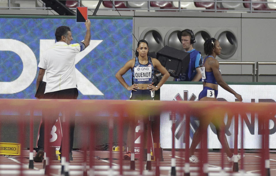 Brianna Mcneal, of the United States, right, walks away after being disqualified for a false start in a the women's 100 meter hurdles heat at the World Athletics Championships in Doha, Qatar, Saturday, Oct. 5, 2019. (AP Photo/Petr David Josek)