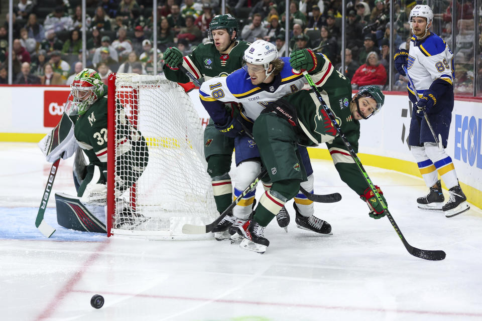 Minnesota Wild right wing Mats Zuccarello, middle right, and center Marco Rossi compete with St. Louis Blues center Robert Thomas for position while Minnesota Wild goaltender Filip Gustavsson and St. Louis Blues left wing Pavel Buchnevich look on during the second period of an NHL hockey game, Tuesday, Nov. 28, 2023, in St Paul, Minn. (AP Photo/Matt Krohn)