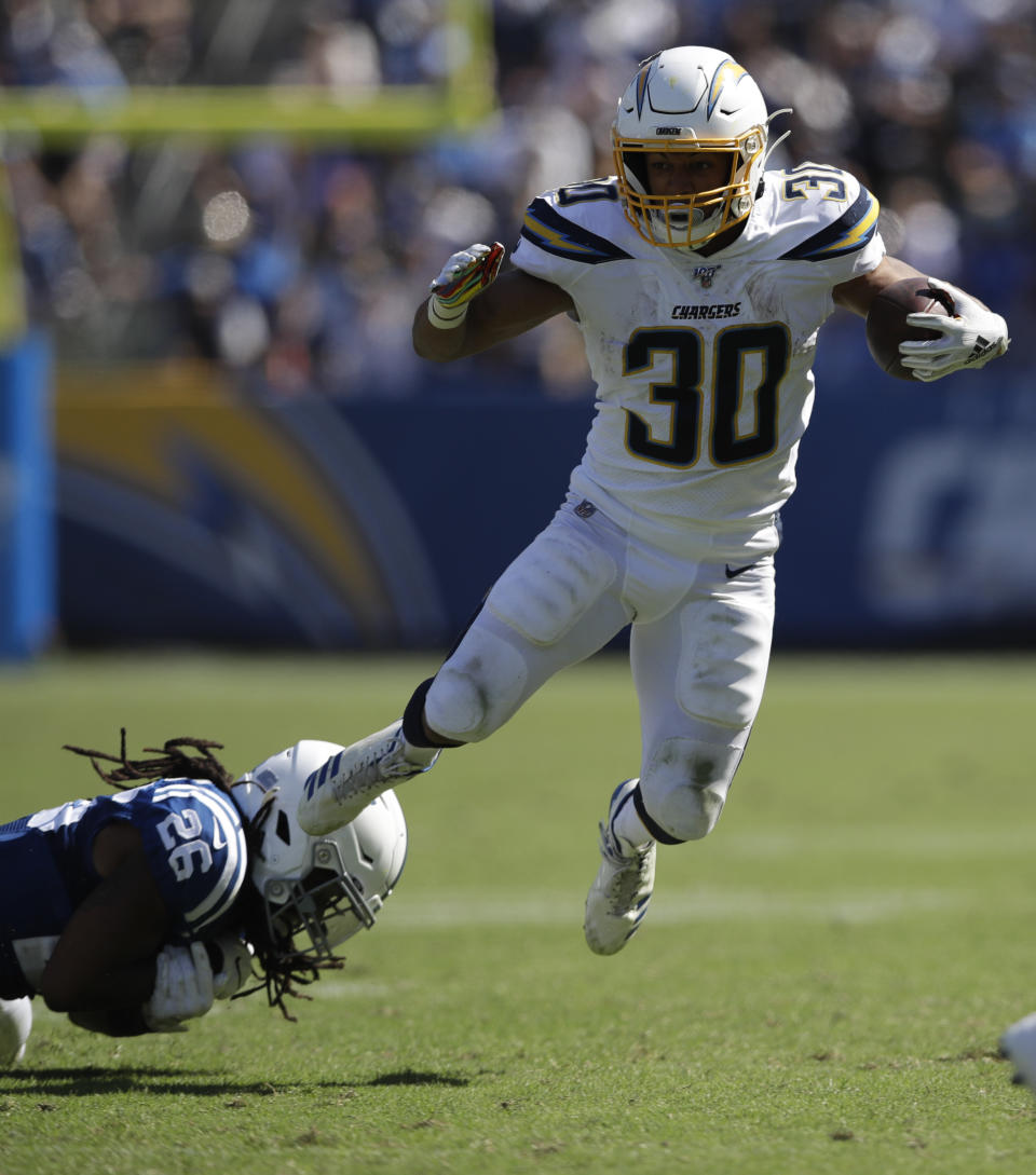 Los Angeles Chargers running back Austin Ekeler, right, breast away form Indianapolis Colts strong safety Clayton Geathers during the second half in an NFL football game Sunday, Sept. 8, 2019, in Carson, Calif. (AP Photo/Marcio Jose Sanchez)