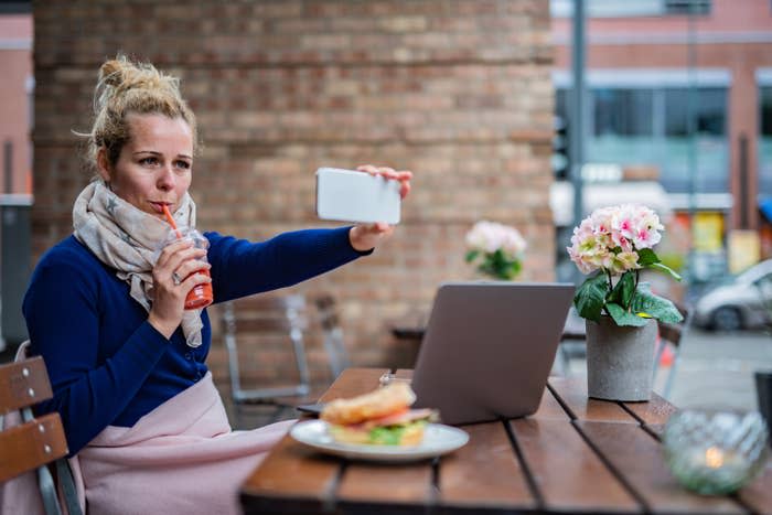 woman taking a selfie at a coffee shop