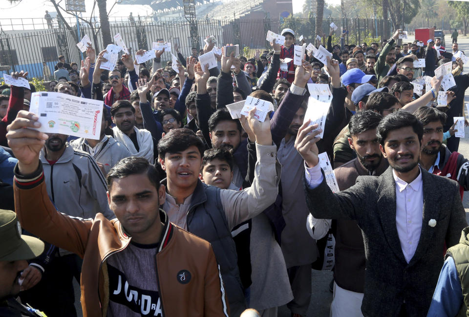 Pakistani cricket fans wait to enter the Gaddafi Stadium in Lahore, Pakistan, Friday, Jan. 24, 2020. Pakistan and Bangladesh play their first T20 of the three matches series. (AP Photo/K.M. Chaudary)