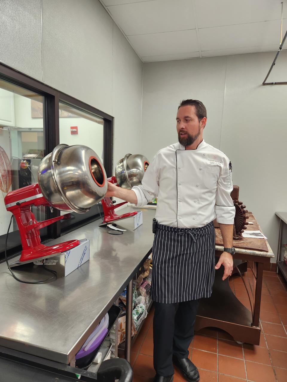 Stand mixers, fitted with an attachment that helps Cain and his team coat things like nuts and truffles with chocolate. (Photo: Holly Kapherr)