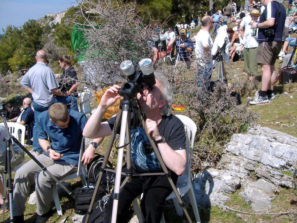 Ryan Milligan at NASA took this photo of a woman using binoculars with solar filters for sun gazing.