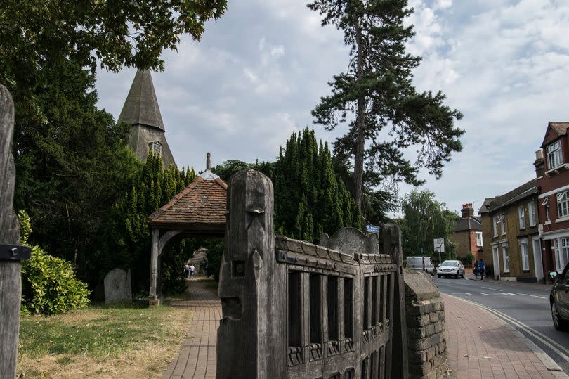 St Mary the Virgin church in Bexley - a wonderful spire decorates this old building and is on the last part of the first section of the London Loop. Lovely spire of the church, a big old wooden gate, a red brick pavement the other side and a nice town street