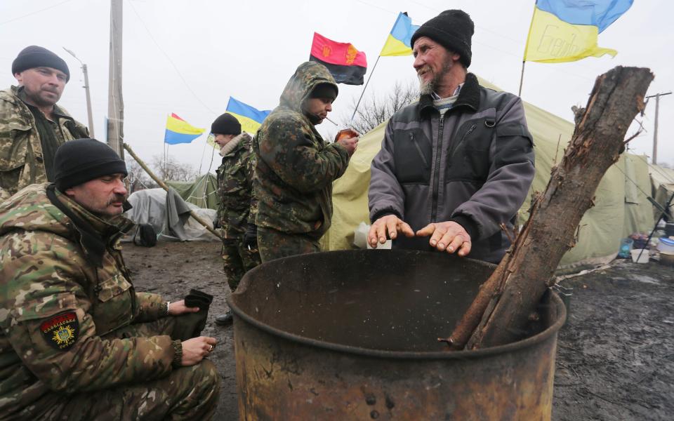 Ukrainian nationalist protesters and military veterans - Credit: ALEKSEY FILIPPOV/AFP