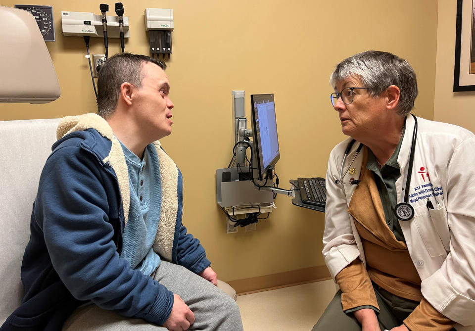 Nurse practitioner Moya Peterson with Christopher Yeo. (Tony Leys for KFF Health News)