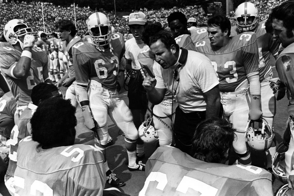 Tennessee linebacker coach Lon Herzbrun talks to Jackie Walker (52), captain of the Vols, while the defense turns the game over to the offense. Before a crowd of 62,990 in Knoxville, Auburn edged the Vols 10-9. 9/25/1971