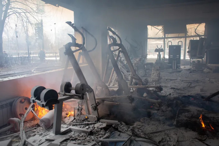 Equipment in a gym smolders the day after an airstrike.