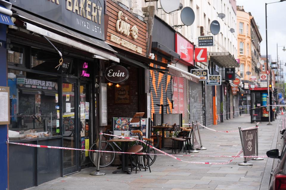 Police tape at the scene of a shooting at Kingsland High Street, Hackney, east London, where three adults and a child have been injured. The Metropolitan Police have said the child is in a serious condition and that they are awaiting updates on the condition of the adults. Police said they were called to the scene at around 9.20pm on Wednesday with specialist firearms officers attending. Picture date: Thursday May 30, 2024.