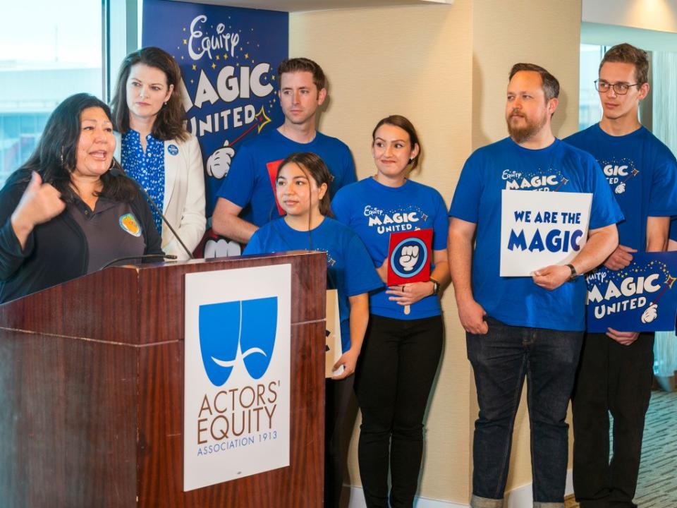 Gloria Alvarado, director of the Orange County Labor Federation, with Disneyland workers. AP