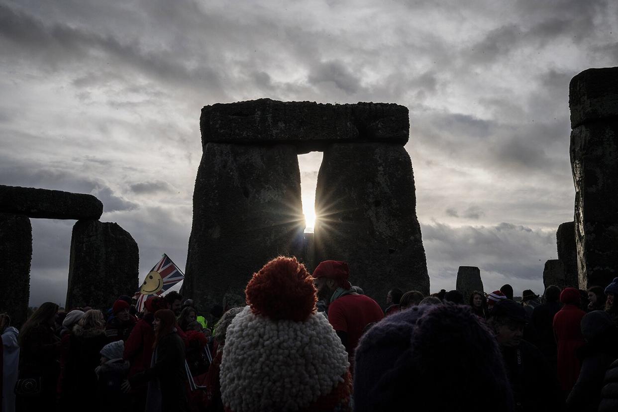 People look towards the sun as druids, pagans and revellers gather at Stonehenge, hoping to see the sun rise, as they take part in a winter solstice ceremony at the ancient neolithic monument of Stonehenge near Amesbury on December 21, 2016 in Wiltshire, England.