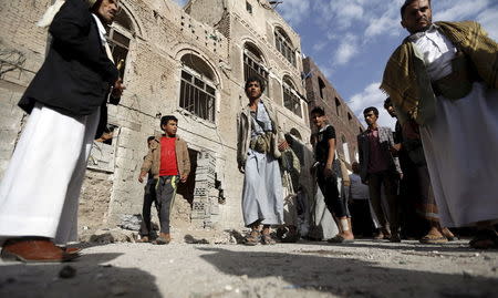 People gather at the site of a car bomb attack in Sanaa June 30, 2015. REUTERS/Khaled Abdullah