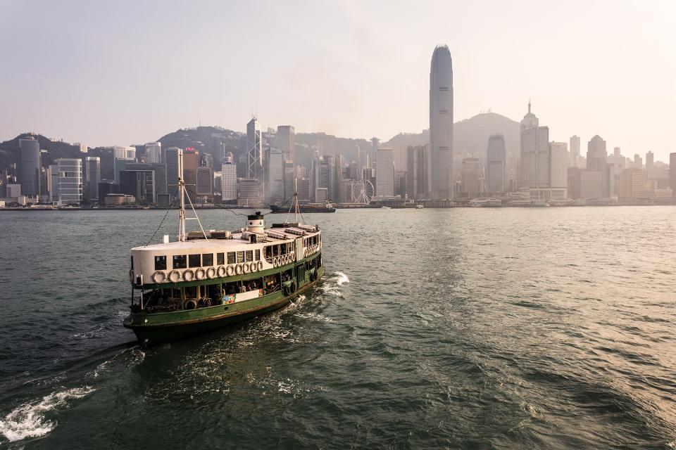 A star ferry leaving its Tsim Sha Tsui pier in Kowloon to reach the Central pier in Hong Kong island at sunset