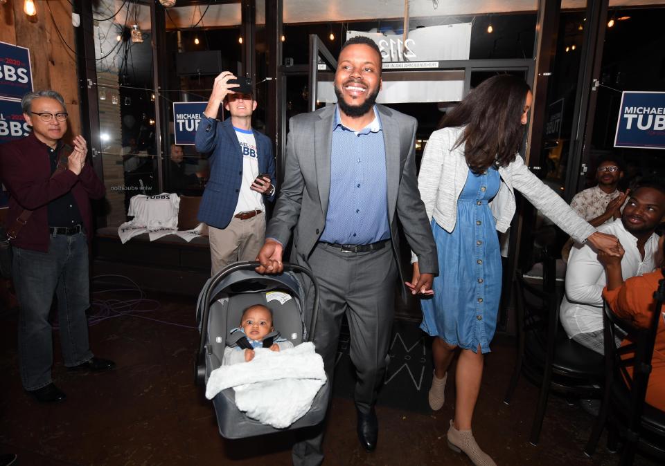 Stockton Mayor Michael Tubbs, holding his month-old son Michael Malakai, arrives at an election night party Tuesday with his wife, Anna Nti-Asare-Tubbs, at Mile Wine Restaurant to greet supporters. [CALIXTRO ROMIAS/THE STOCKTON RECORD]