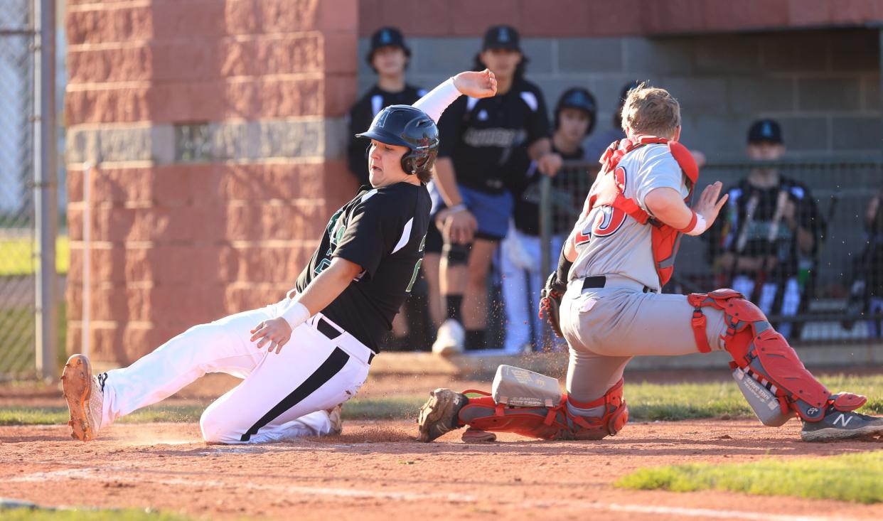 Aurora's Nathan Balkissoon, left, shown in an earlier game, hit a triple in the Greenmen's tournament game against Lake.