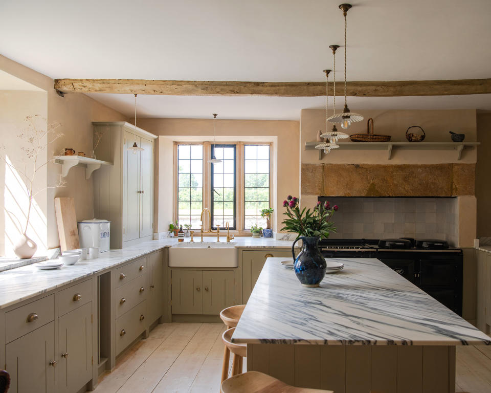 Neutral kitchen with olive cabinets and marble countertop