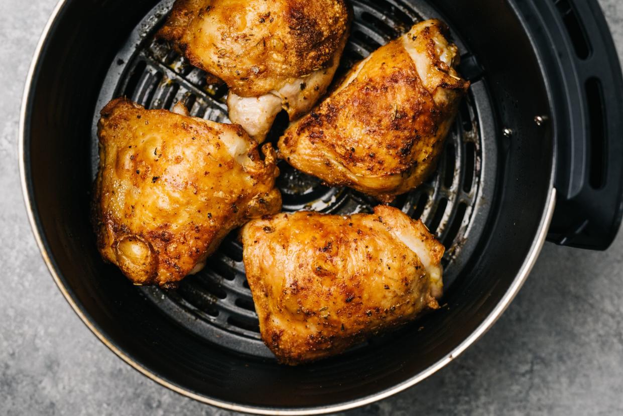 Four spicy air fried chicken thighs in an air fryer in Frederick, MD, United States