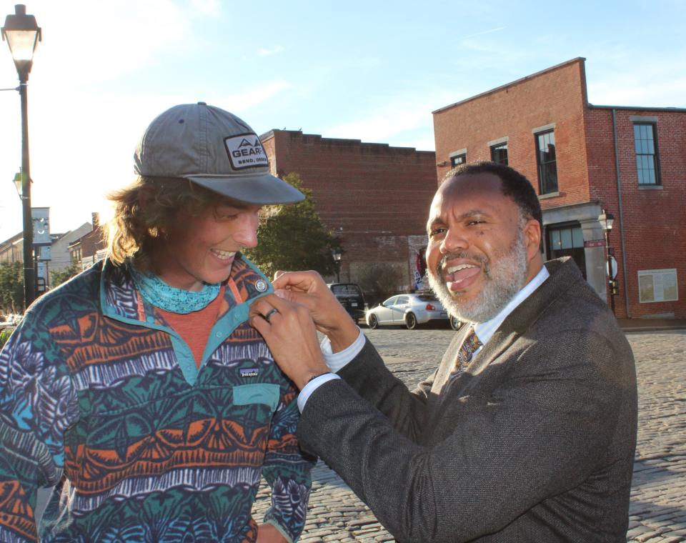 Mayor Samuel Parham gifts tourist Holden Minor Ringer with a city of Petersburg pin on Feb. 29, 2024.
