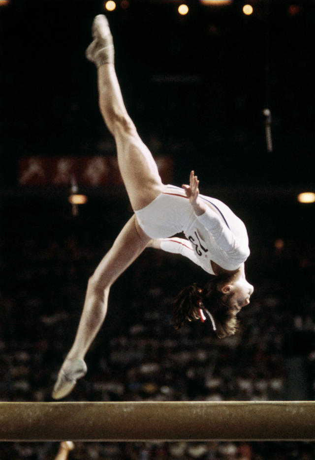 Rumanian champion Nadia Comaneci, aged 14, performs during Olympic beam event 21 July 1976 in Montreal where she was awarded with ten points in two exercices and captured 3 gold medals (beam, uneven bars and general competition). Legendary gymnast, during her career Nadia Comaneci captured four Olympic gold medals (1976 : beam, uneven bars and general competition - 1980, beam) and was the first to score 10 in her discipline