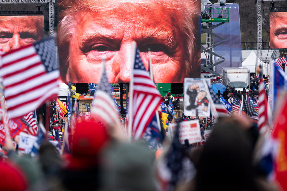 An image of President Donald Trump appears on video screens (Bill Clark / CQ-Roll Call Inc. via Getty Images file)