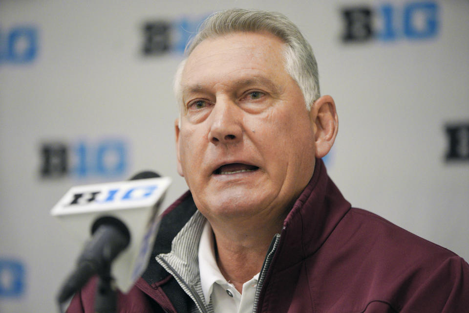 FILE - In this May 21, 2019, file photo, Minnesota coach John Anderson speaks during a news conference ahead of the Big Ten NCAA college baseball tournament in Omaha, Neb. A new rule intended to help speed up the game also could thwart attempts to steal signs in college baseball. The NCAA will allow a pitcher to wear a wristband with a signal card when the season opens Friday, Feb. 14, 2020, allowing him and the catcher to look into the dugout to get pitch calls and eliminating the need for the catcher to relay the call with hand signs. (AP Photo/Nati Harnik, File)